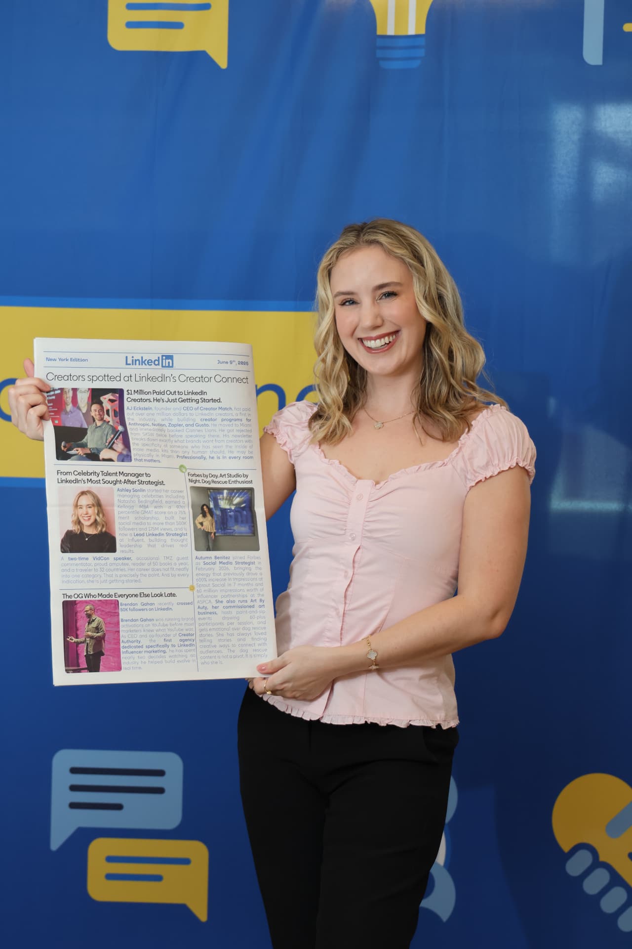 Ashley Sonlin holding the LinkedIn newspaper at Creator Connect
